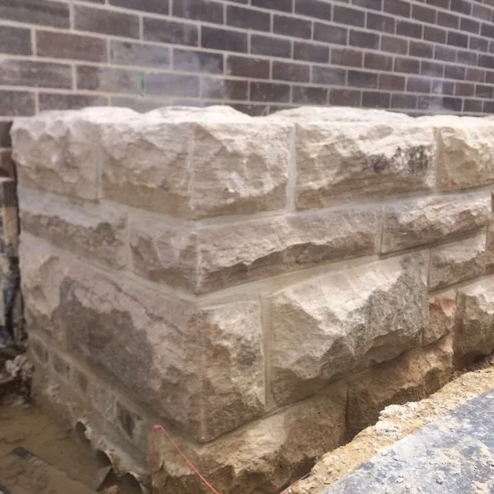 Decorative stone capital with ornamental carvings clamped for repair