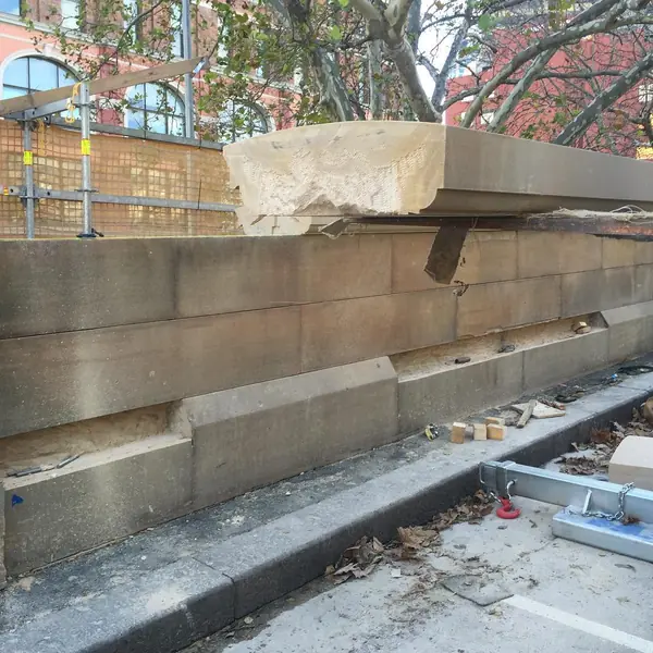 Heritage church brick restoration with worker on-site