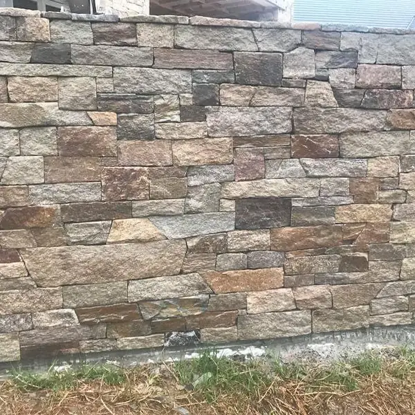 Minas chiselling sandstone with mallet on heritage wall