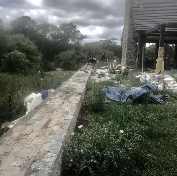 Rustic sandstone steps winding through bushland garden