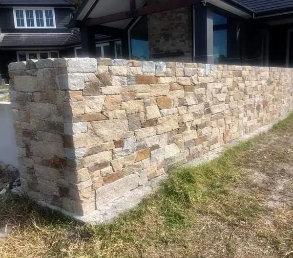 Minas shaping sandstone with mallet and chisel on-site