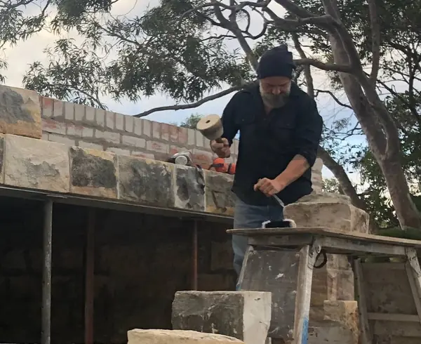 Heritage church brick restoration with cement mixer