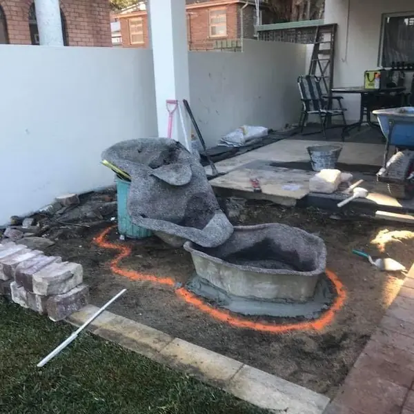 Natural stone fireplace surround under construction