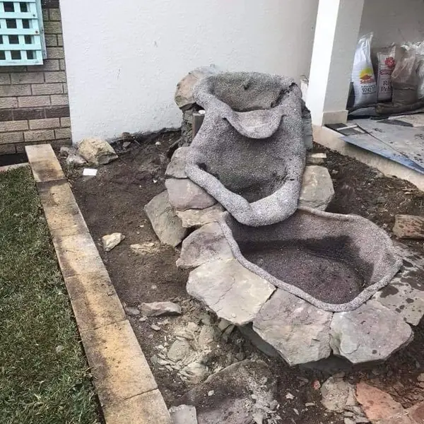 Stone cladding being applied to interior fireplace wall
