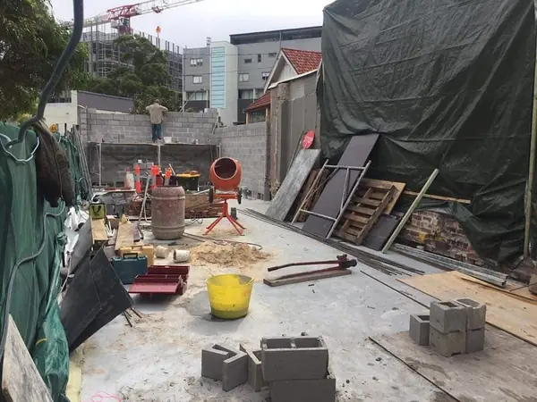 Construction site with concrete block wall and equipment