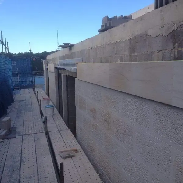 Heritage sandstone harbour wall with water views