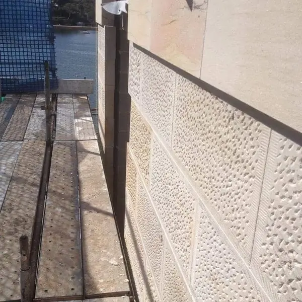 Sandstone seawall construction at harbourside location