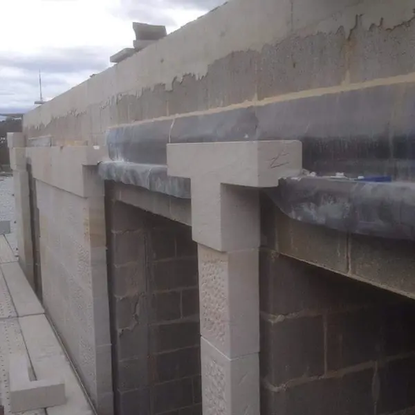 Completed sandstone wall section at waterfront property