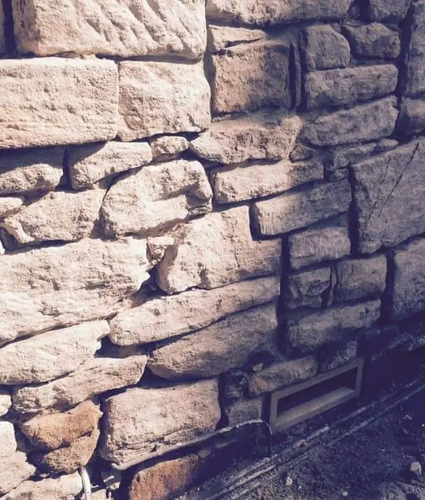 Sandstone block being shaped by hand on worksite