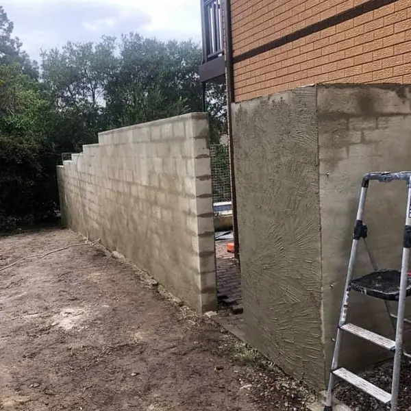 Completed rendered boundary wall with smooth finish