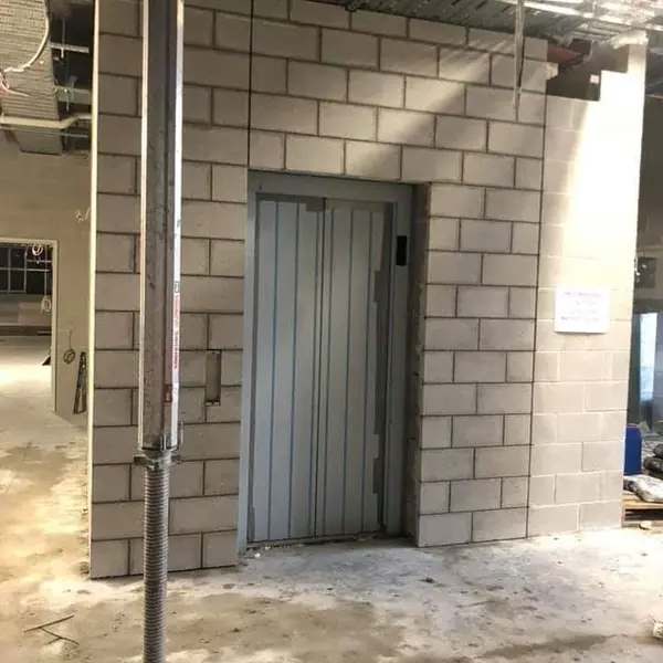 Concrete block wall construction around lift shaft