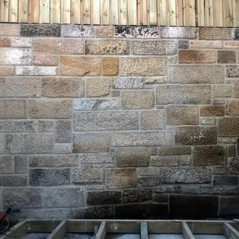 Aged sandstone block wall undergoing remedial works