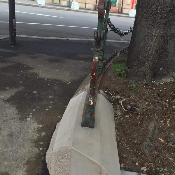 Heritage sandstone kerb stone with iron post streetscape