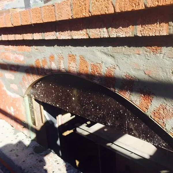 Heritage brick arch with render repair in progress