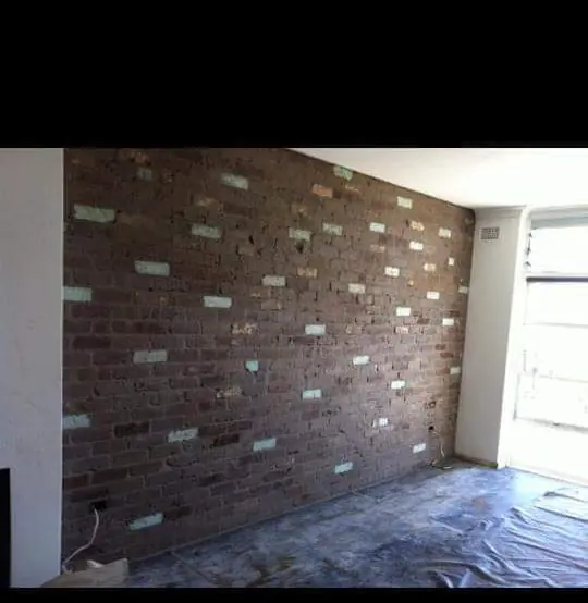 Exposed recycled brick interior feature wall with patina