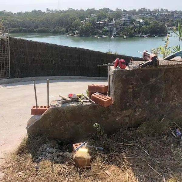 Waterfront stone wall with harbour views beyond