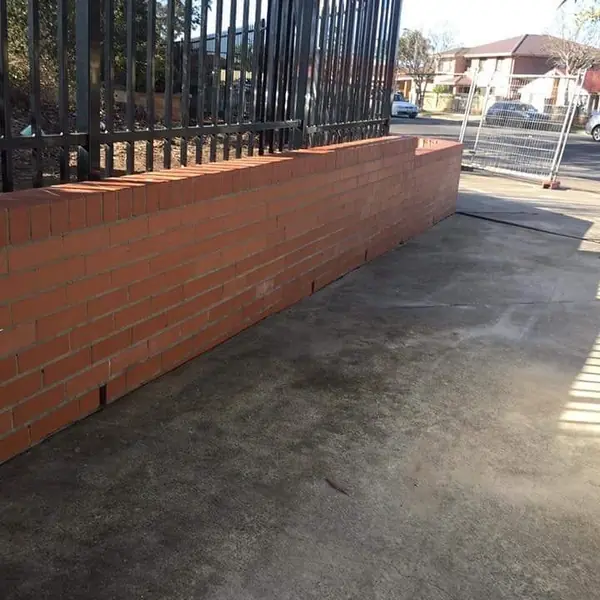 New brick boundary wall with fence railing detail