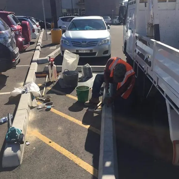 Concrete kerb and channel installation at car park