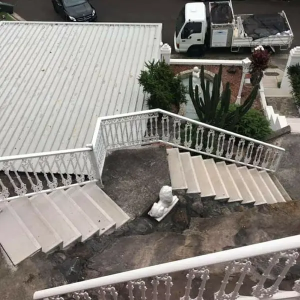 Grand concrete staircase with balustrades requiring repair