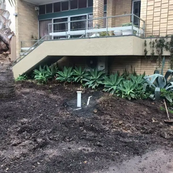 Curved sandstone pathway leading to residential entrance