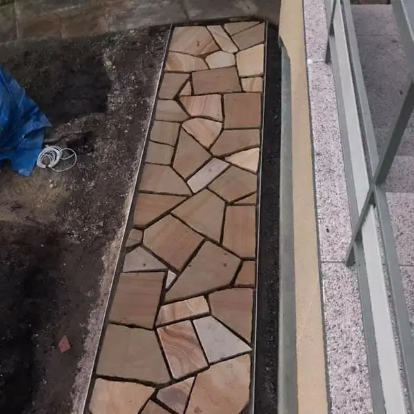 Finished sandstone pathway with mature garden setting