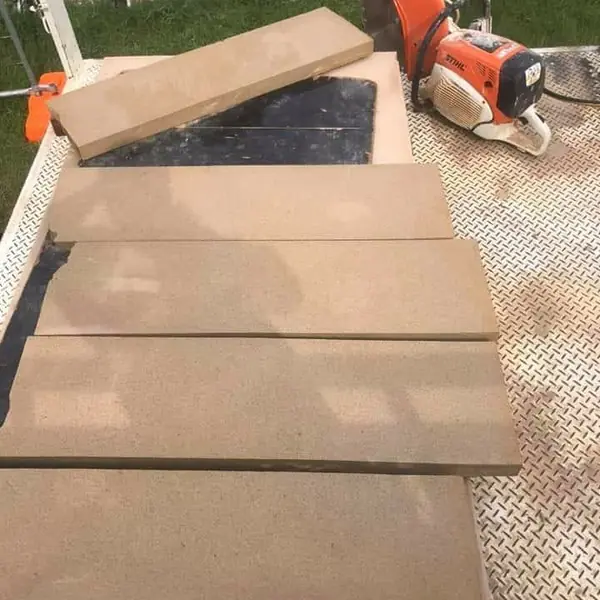 Cut sandstone coping blocks on truck with stone saw