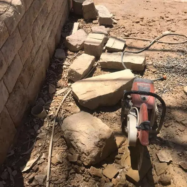 Sandstone veneer cladding on exterior retaining wall