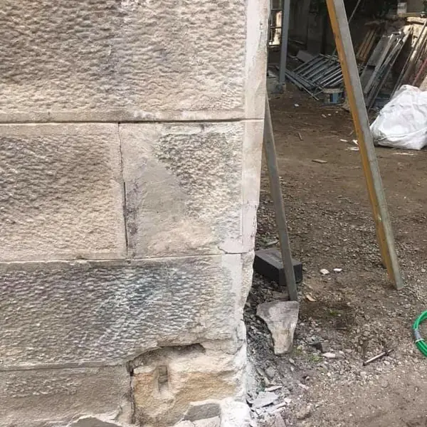 Sandstone block wall with doorway opening in new build