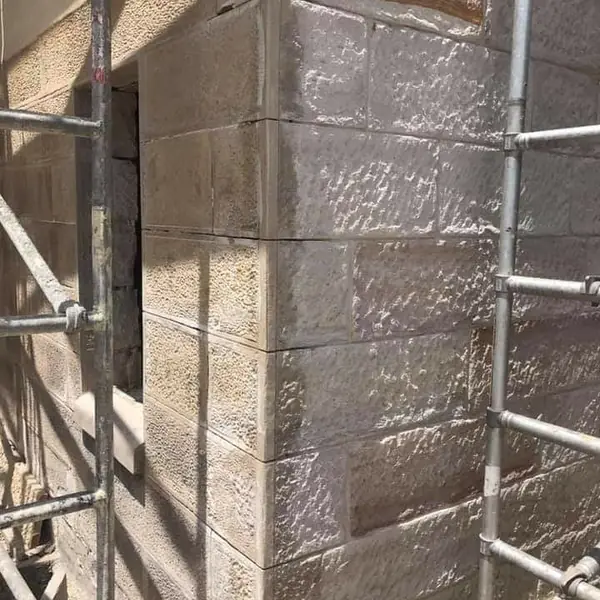 Completed sandstone block building exterior wall