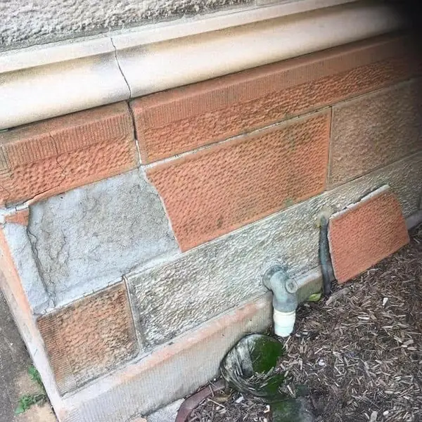 Heritage sandstone and brick wall with replacement blocks