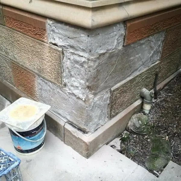 Mixed sandstone and brick heritage wall restoration