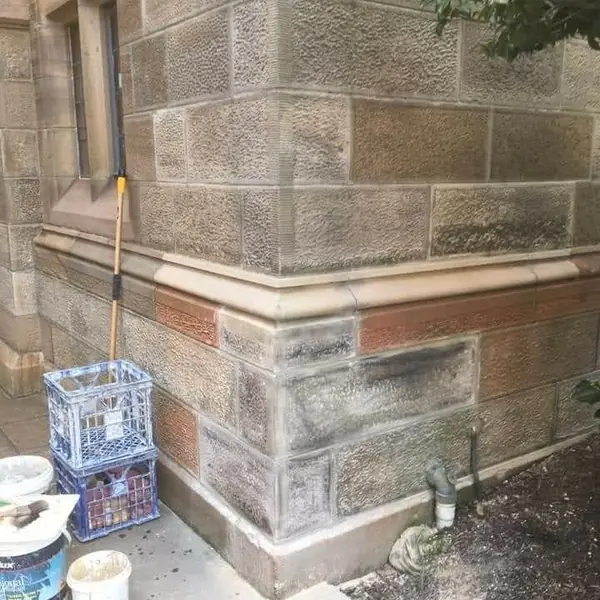 Brick and stone heritage wall with new mortar joints