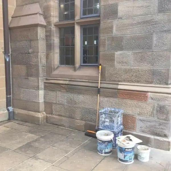 Heritage wall restoration with matching replacement blocks