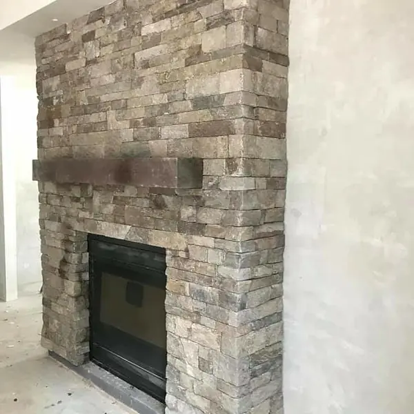 Natural stone fireplace feature wall with timber mantel