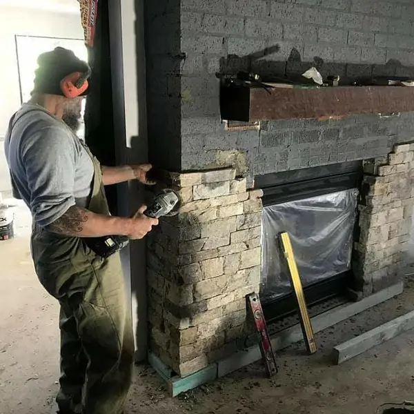 Interior stone cladding fireplace during installation