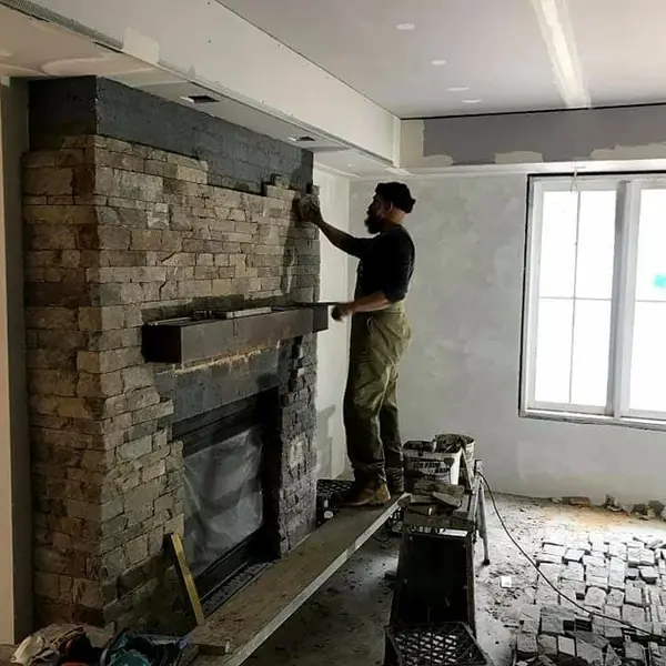 Completed stone veneer fireplace from side angle
