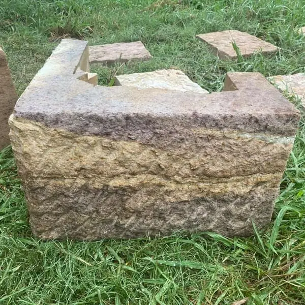Reclaimed sandstone block on grass ready for restoration