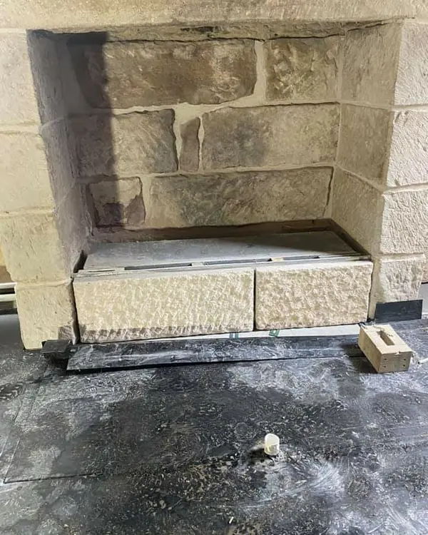 Finished hand-textured sandstone slab on workbench