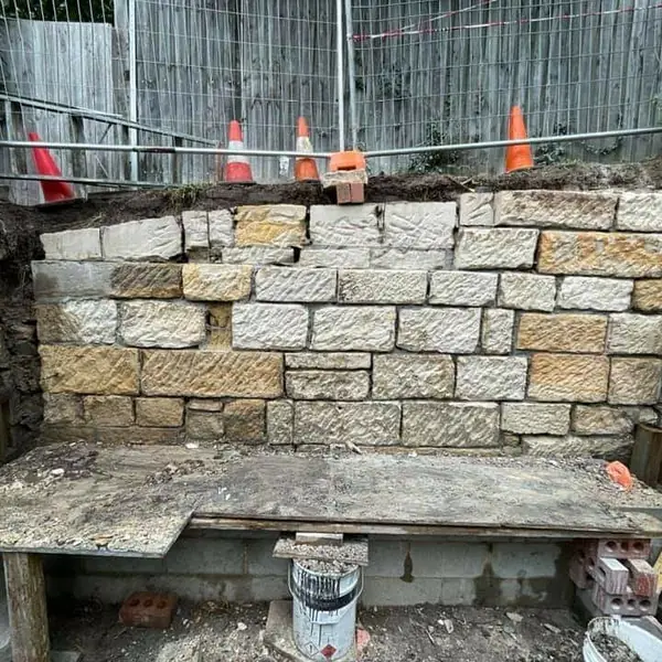 Sandstone block retaining wall under construction at harbour