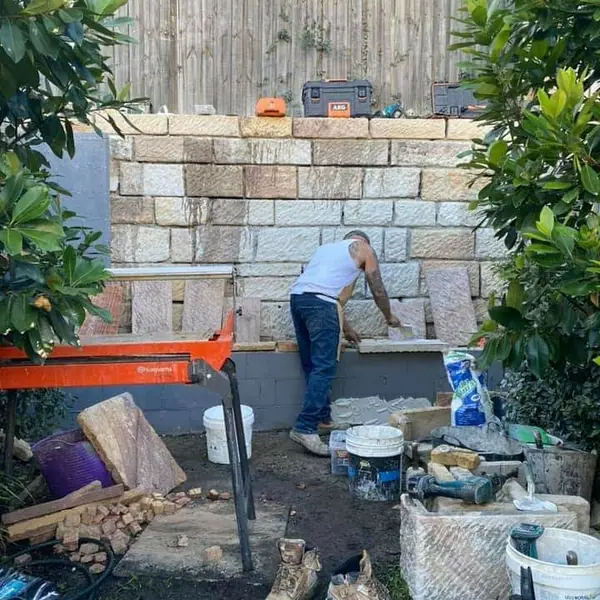 Harbour sandstone retaining wall with new mortar joints