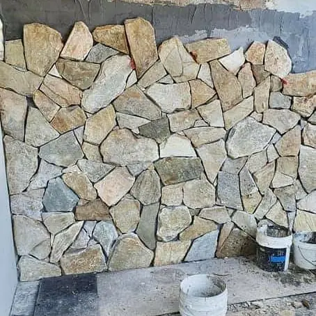 Residential stone cladding nearing completion on facade