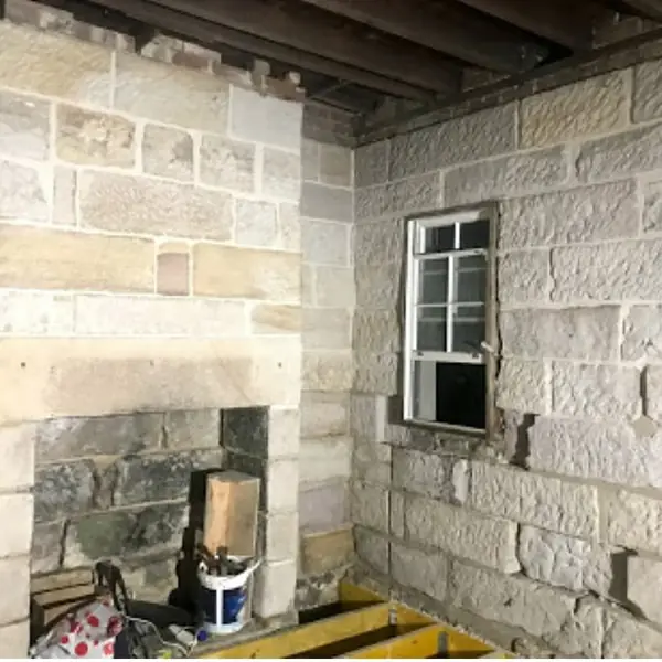 Sandstone block feature wall in premium bathroom design