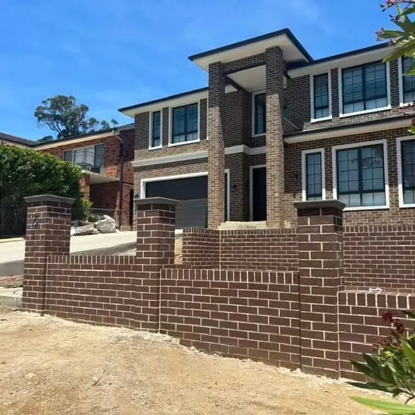 Retaining wall and stairs under construction at residence