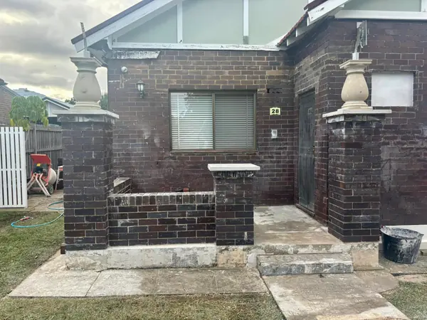 Brick house with sandstone entry pillars and balustrades