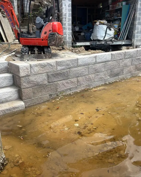 Mini excavator and block retaining wall construction